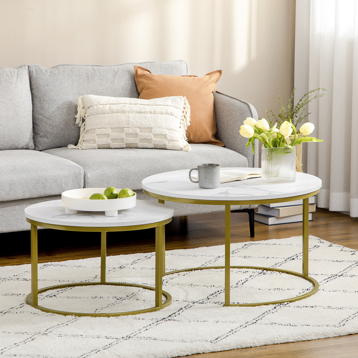 Set of two round marble‑effect nesting coffee tables.