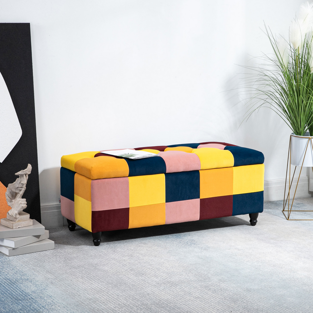 Colour‑block velvet storage ottoman with button‑tufted lid.