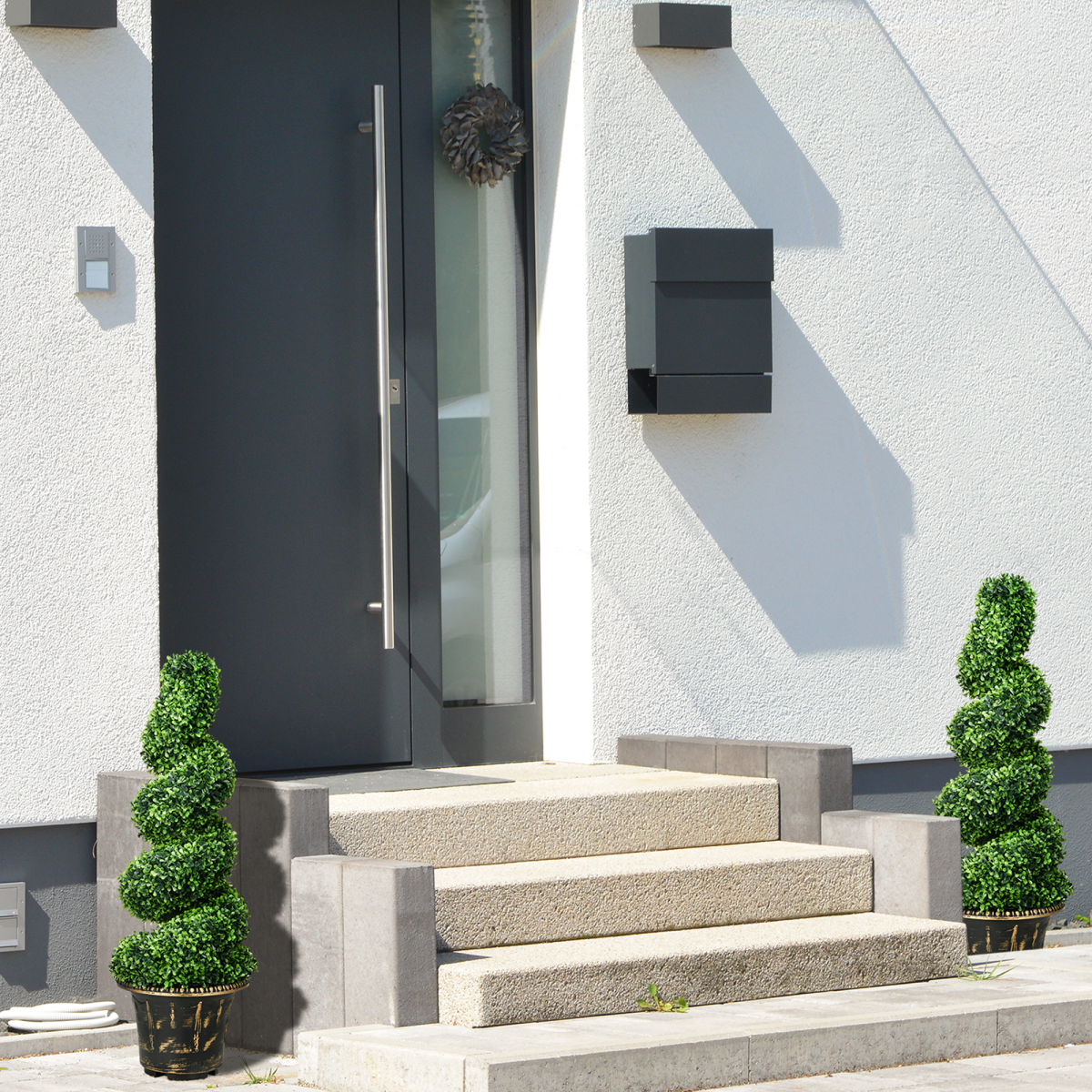 Set of two 90cm spiral boxwood topiary trees.
