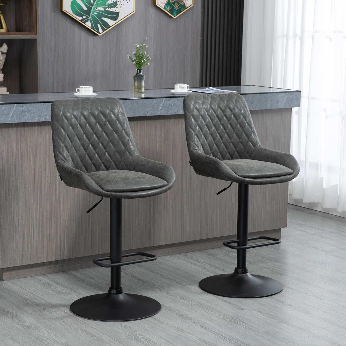 Set of two adjustable grey swivel bar stools with chrome base.