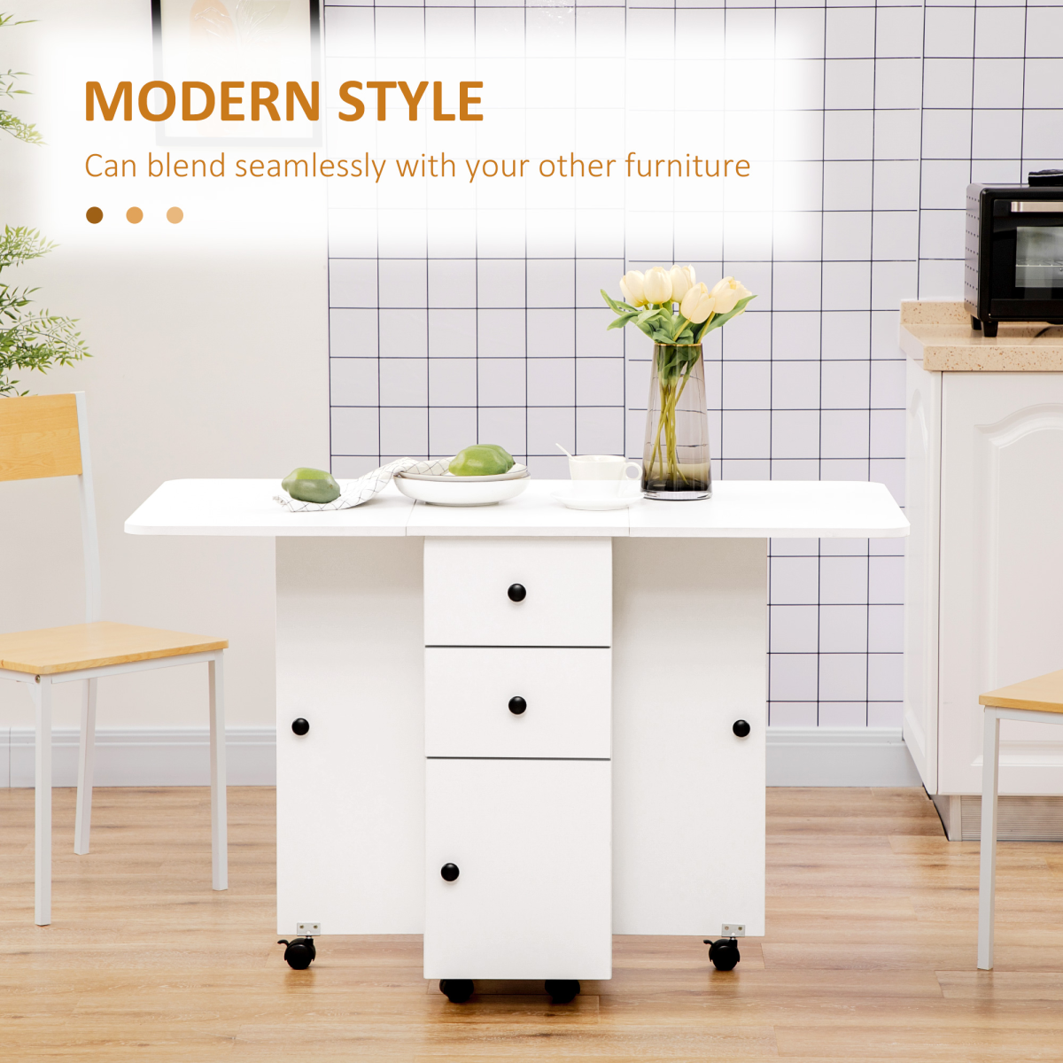 White drop‑leaf folding dining table with storage drawers.