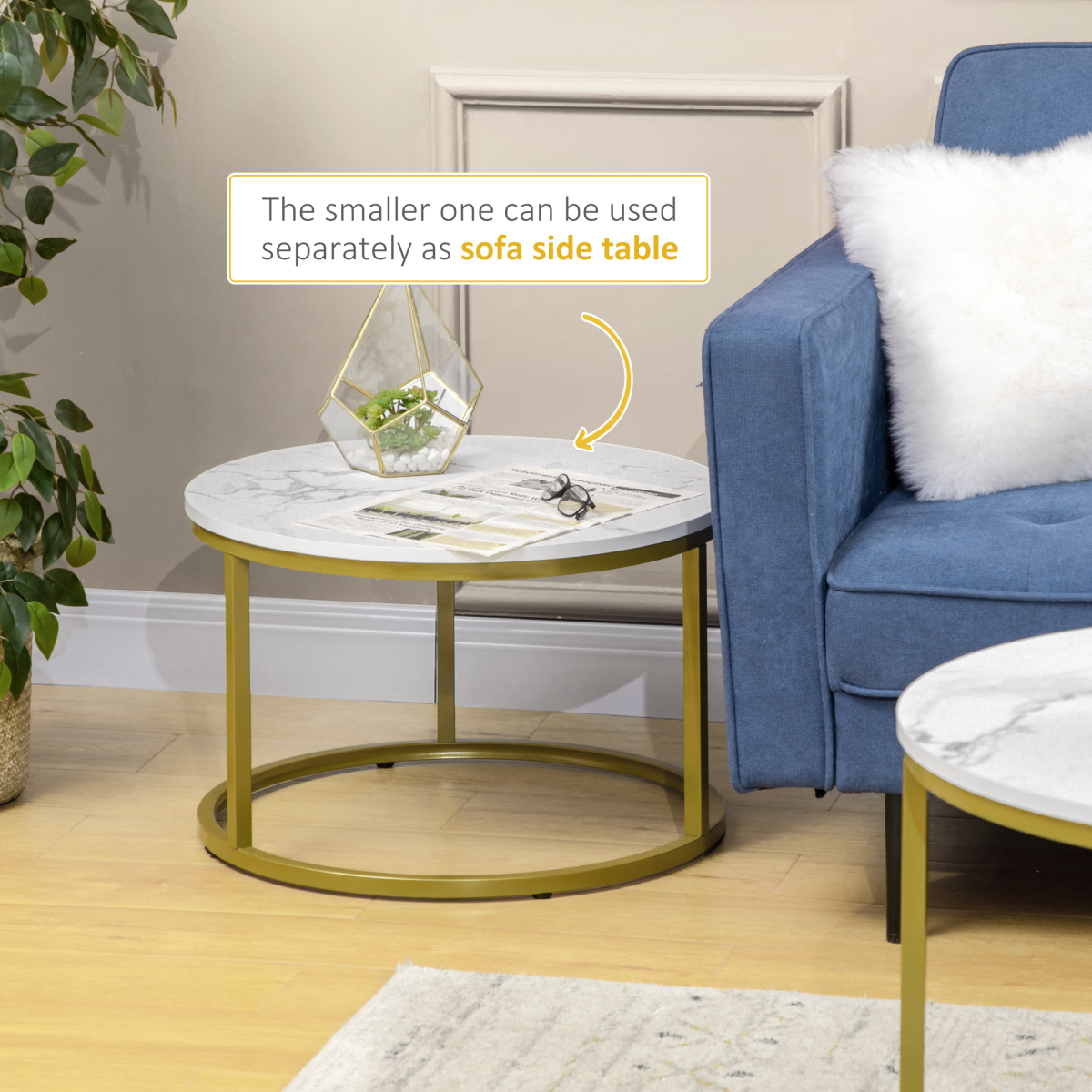 Set of two round marble‑effect nesting coffee tables.