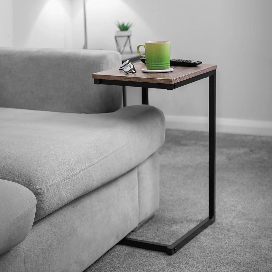 Black C‑shaped slide‑under side table.