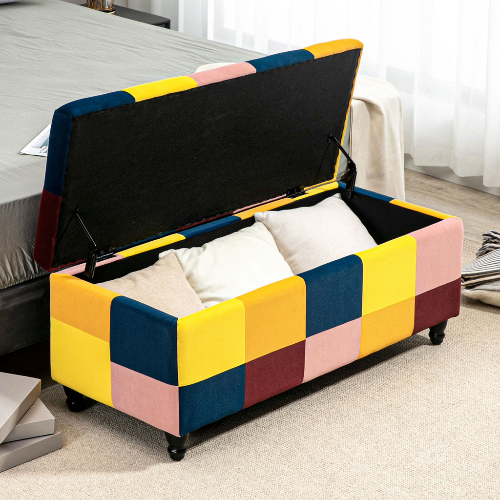 Colour‑block velvet storage ottoman with button‑tufted lid.