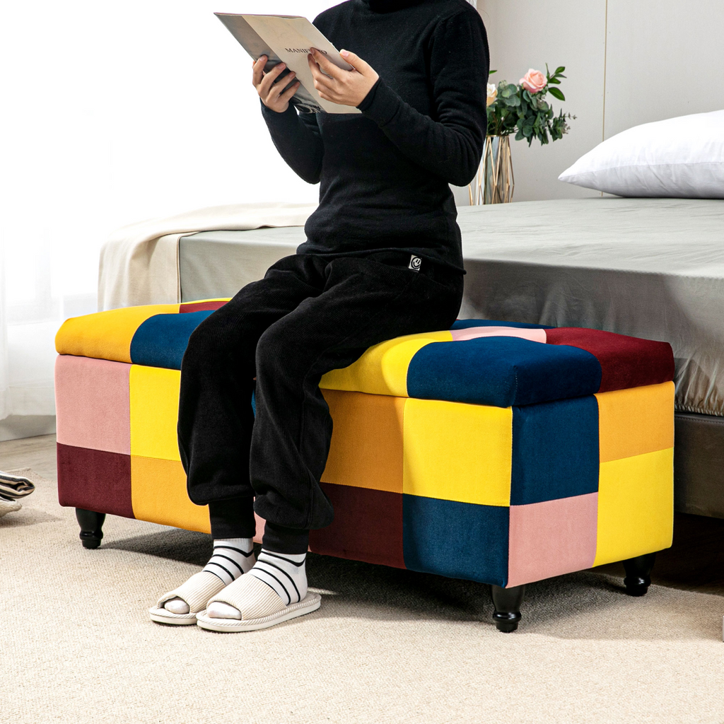 Colour‑block velvet storage ottoman with button‑tufted lid.