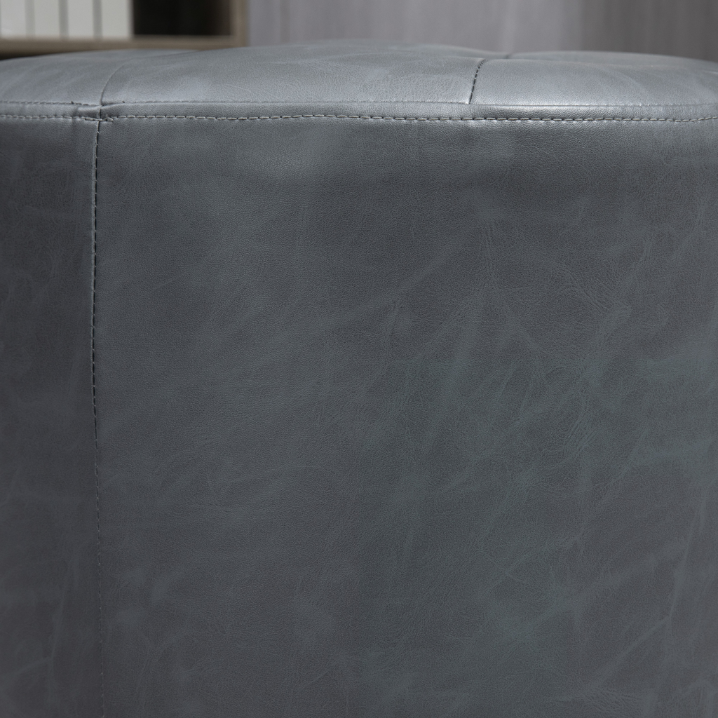 Grey 360‑degree swivel footstool with padded seat.