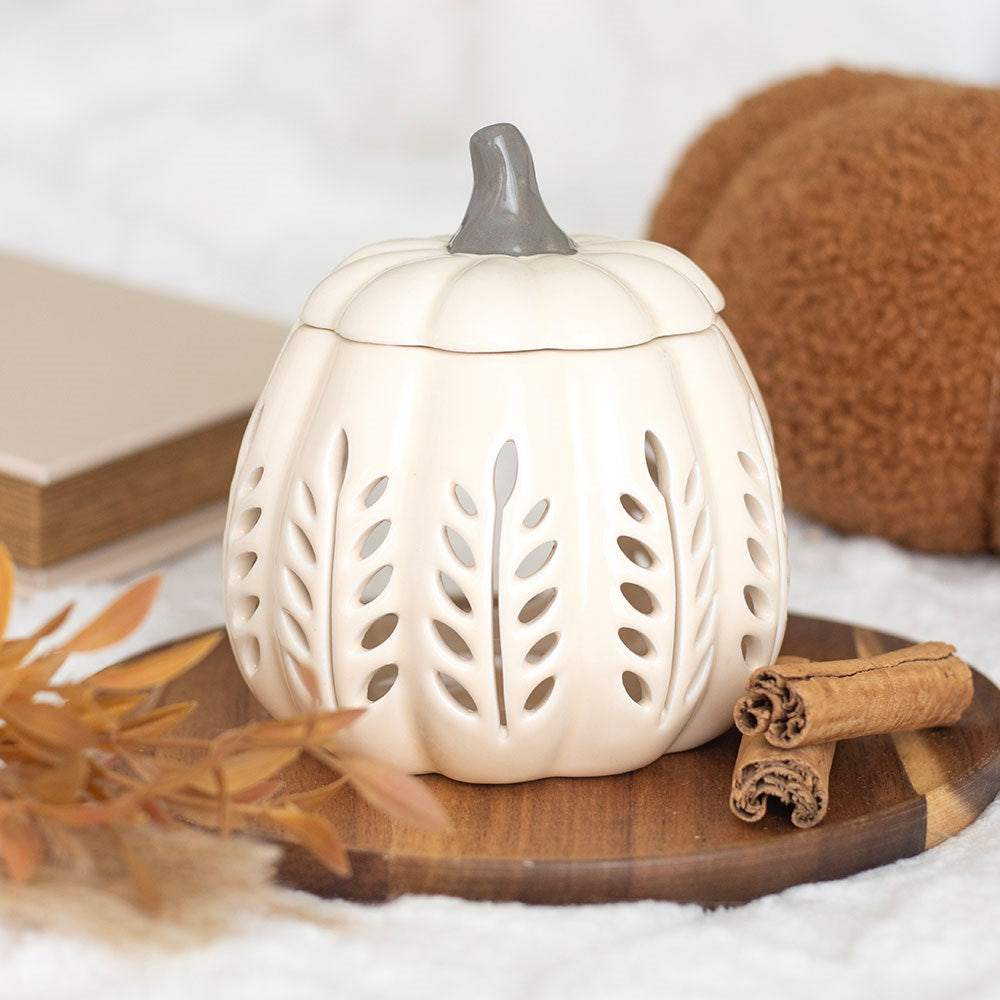 Cream ceramic pumpkin oil burner with cut-out leaf detail