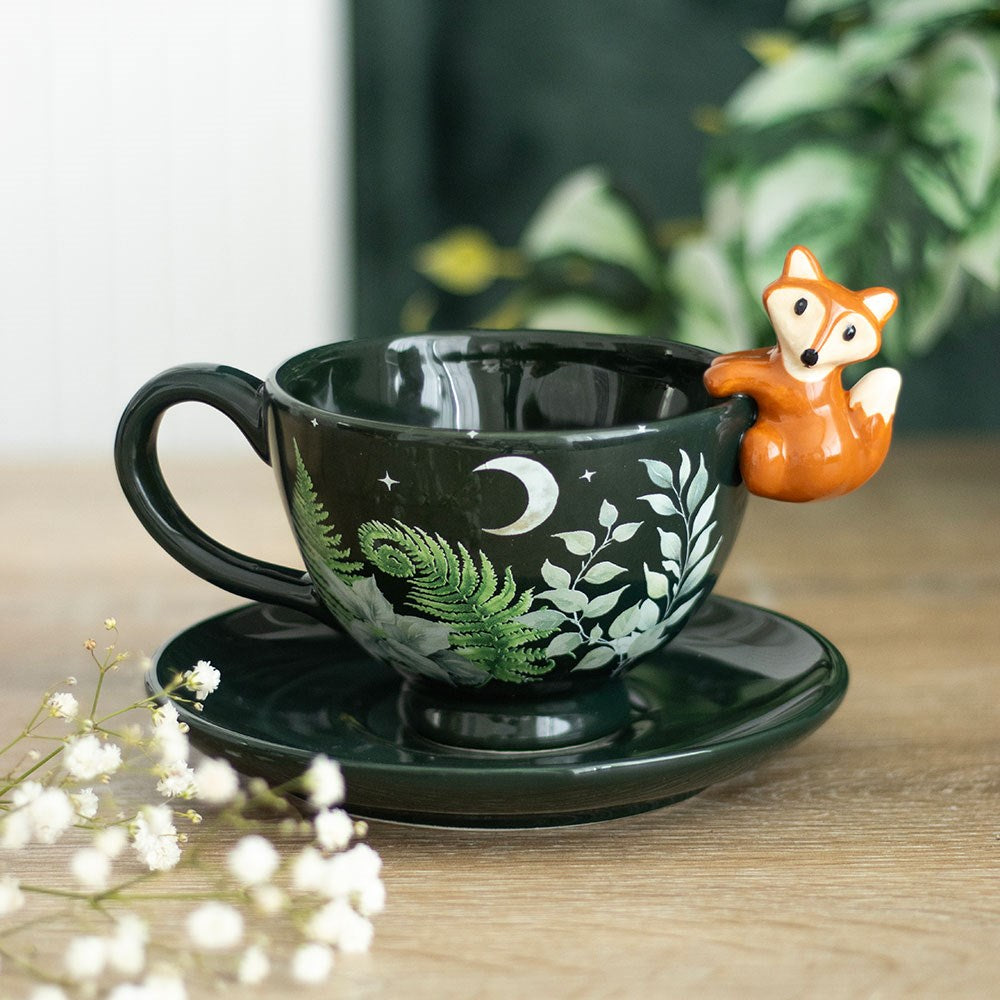 Green foliage ceramic teacup and saucer with a fox at the rim