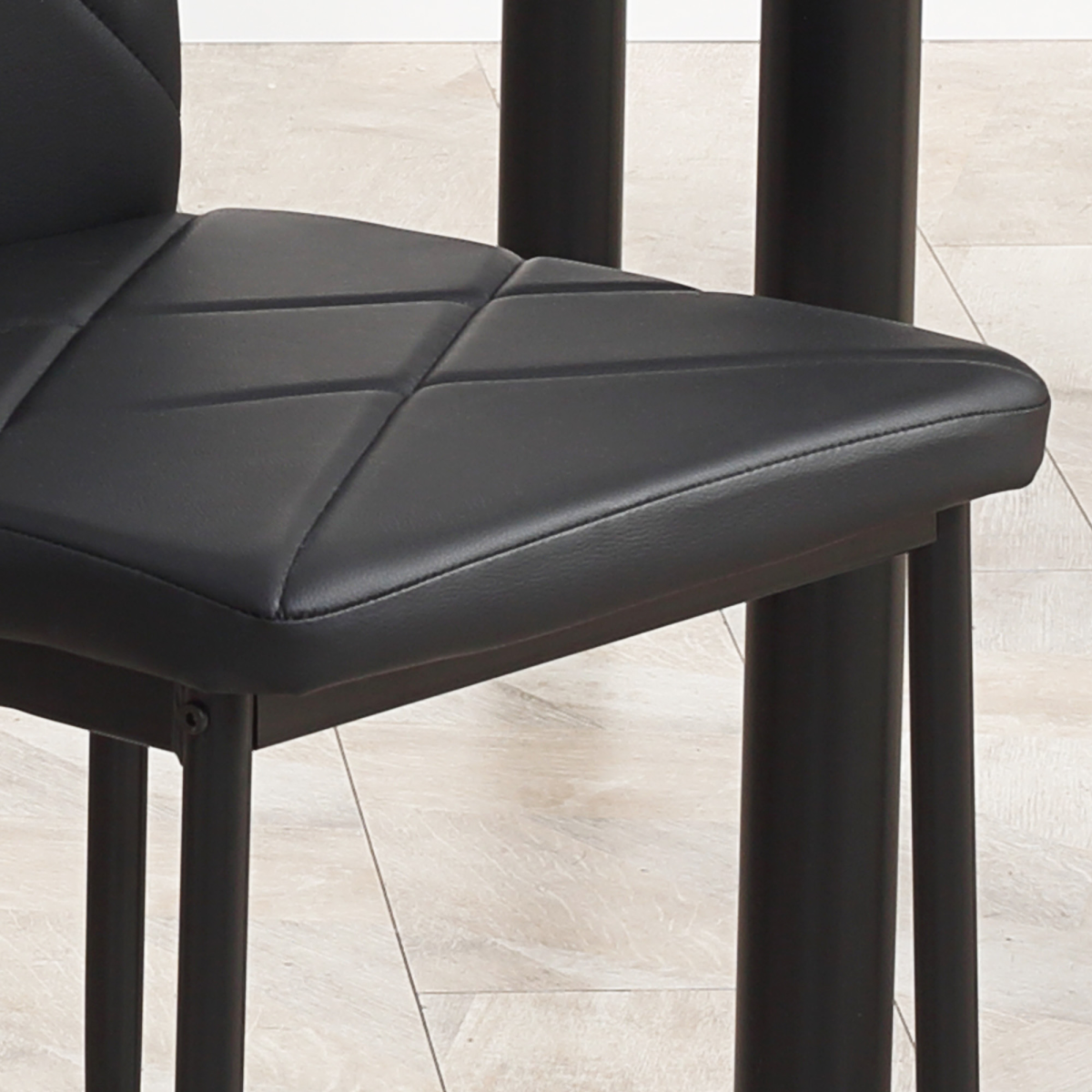 Modern dining table set for four with padded chairs.8.png
