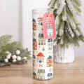 Tall glass tube candle printed with a Christmas village scene, with a hanging tag