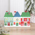 Ceramic terrace of three little Christmas houses holding a tealight