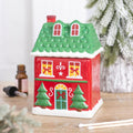 Red ceramic Christmas house oil burner with a green tiled lift-off roof and lit windows